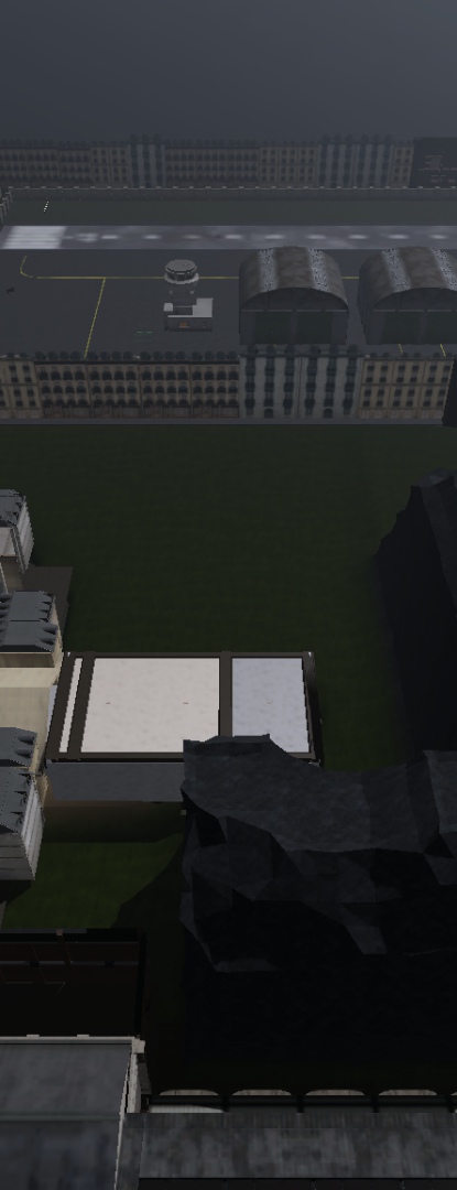 Studio view of lot A: a large empty grass field between building rows